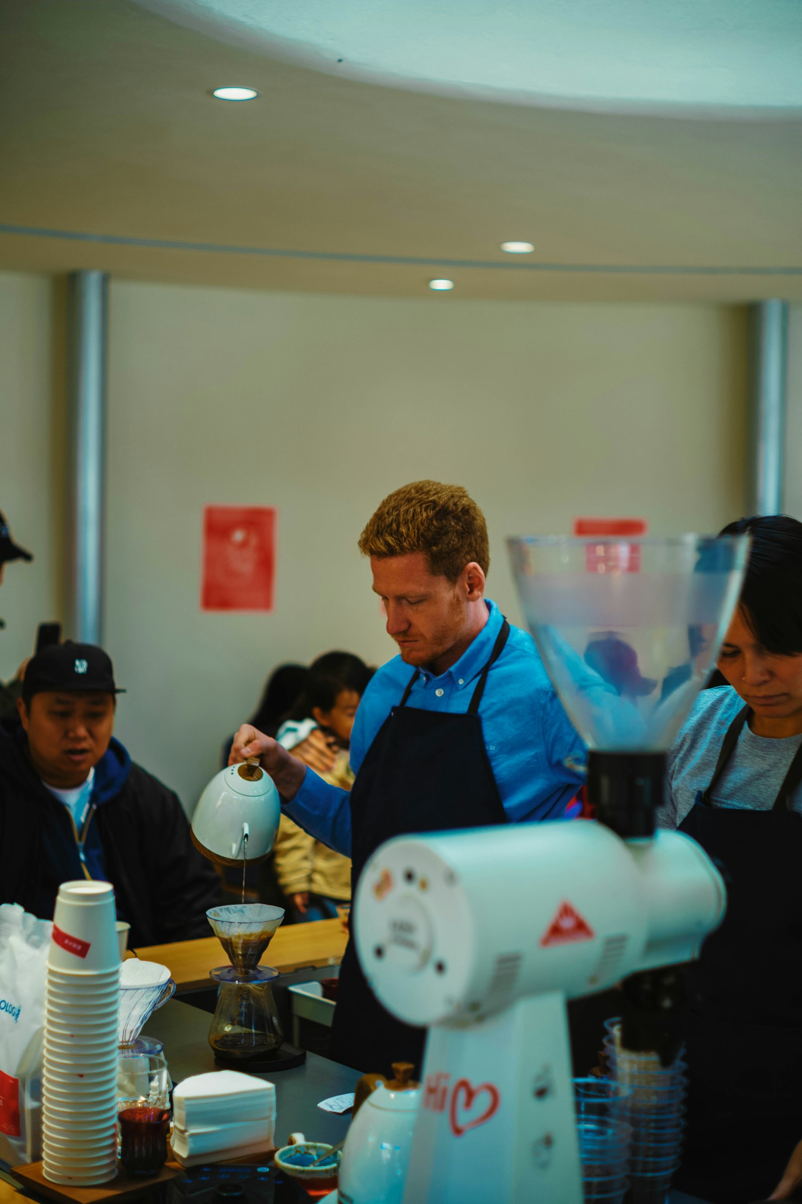 A barista preparing pour-over coffee
